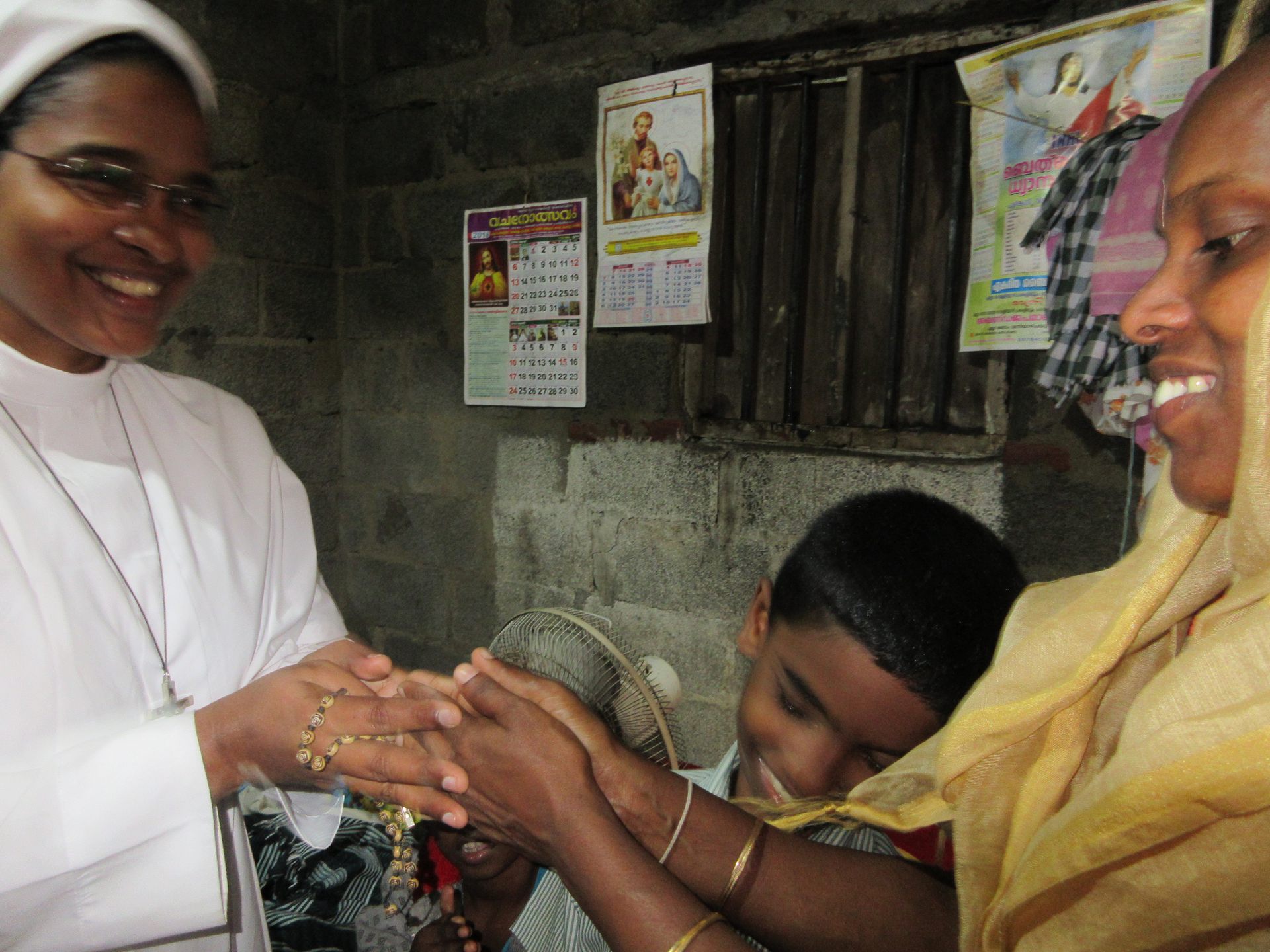 Sister praying with a family